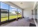 Relaxing screened-in patio featuring brick flooring and a tranquil view of the home's backyard at 3186 Sailing Pier Ave, Winter Garden, FL 34787