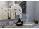 Bathroom with a granite countertop, a decorative flower arrangement, and a large clock on the wall at 3322 Wye Oak Dr, Apopka, FL 32703
