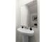 Elegant powder room featuring a pedestal sink, modern faucet, decorative accents, and neutral walls at 3322 Wye Oak Dr, Apopka, FL 32703