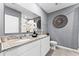 Bathroom featuring double sinks with granite countertops and a large decorative clock on the wall at 3322 Wye Oak Dr, Apopka, FL 32703