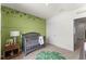 Bedroom features include a wooden crib, monkey-themed wall decor, and accent furniture at 3322 Wye Oak Dr, Apopka, FL 32703