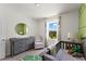 This Bedroom offers a changing table, crib, glider, and a scenic window view at 3322 Wye Oak Dr, Apopka, FL 32703