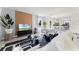 Comfortable living room boasts tile floors, neutral tones, television, and open layout to the kitchen at 3322 Wye Oak Dr, Apopka, FL 32703