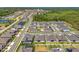 An aerial view showcases neighborhood streets, homes, pools and green spaces near a forested area at 3351 Pine Timber Pt, Oviedo, FL 32765