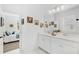 Bright bathroom featuring dual sinks, white cabinetry and modern fixtures at 3351 Pine Timber Pt, Oviedo, FL 32765