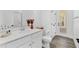 Bright bathroom featuring a white vanity, toilet, and doorway to another room at 3351 Pine Timber Pt, Oviedo, FL 32765
