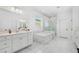 Bright bathroom with a soaking tub, glass enclosed shower, and double sink vanity at 3351 Pine Timber Pt, Oviedo, FL 32765