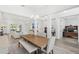 Open-concept dining room with a large table, bench seating, and views into the living area at 3351 Pine Timber Pt, Oviedo, FL 32765