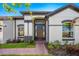 Elegant front door with sidelights, flanked by manicured landscaping and a brick walkway at 3351 Pine Timber Pt, Oviedo, FL 32765