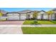 Beautiful one-story home featuring a well-manicured lawn, a three-car garage, and a brick driveway at 3351 Pine Timber Pt, Oviedo, FL 32765