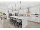 Bright kitchen with a large island, stainless appliances, pendant lighting, and gray and white color palette at 3351 Pine Timber Pt, Oviedo, FL 32765