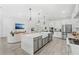 Modern kitchen with a large island, stainless steel appliances, and open view to the living room at 3351 Pine Timber Pt, Oviedo, FL 32765