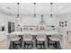 Spacious kitchen with an oversized island, breakfast bar, stainless appliances, and modern pendant lighting at 3351 Pine Timber Pt, Oviedo, FL 32765