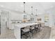 Bright kitchen with a large island, breakfast bar seating, stainless appliances, and view to dining area at 3351 Pine Timber Pt, Oviedo, FL 32765