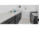 Laundry room with a dark countertop and black washer and dryer at 3351 Pine Timber Pt, Oviedo, FL 32765