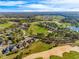 The aerial view shows the home's location in a lush golf course community with mature trees and manicured lawns at 34000 Fortunado St, Sorrento, FL 32776