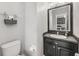Bathroom features a framed mirror, vanity, toilet, and tiled floor at 34000 Fortunado St, Sorrento, FL 32776