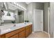 Well-lit bathroom features a double sink vanity and a shower with clear glass door at 34000 Fortunado St, Sorrento, FL 32776