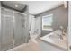 Modern bathroom with a glass-enclosed shower, soaking tub, and double sinks at 34000 Fortunado St, Sorrento, FL 32776