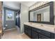 Well-lit bathroom features a double sink vanity with a shower and window at 34000 Fortunado St, Sorrento, FL 32776
