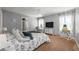 Inviting bedroom with a plush floral bedding, a ceiling fan, and natural light from large windows at 34000 Fortunado St, Sorrento, FL 32776