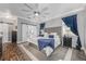 Spacious bedroom with tufted headboard, stylish decor, and access to a modern en-suite bathroom at 34000 Fortunado St, Sorrento, FL 32776