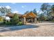 This is a clubhouse featuring stone columns, a wooden beam entrance, and a brick paver walkway at 34000 Fortunado St, Sorrento, FL 32776