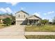 Two-story home featuring a large driveway and well-maintained landscaping at 34000 Fortunado St, Sorrento, FL 32776