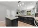 Well-lit kitchen with a central island, a view into the living room, and stainless steel appliances at 34000 Fortunado St, Sorrento, FL 32776