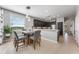 Charming kitchen with a cozy breakfast nook illuminated by a stylish pendant light and large window at 34000 Fortunado St, Sorrento, FL 32776