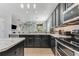 A modern kitchen with marble countertops, a breakfast bar, and stainless steel appliances at 34000 Fortunado St, Sorrento, FL 32776