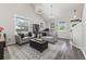 A bright and spacious living room featuring modern decor, hardwood floors, and large windows at 34000 Fortunado St, Sorrento, FL 32776