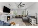Bright living room featuring a fireplace, large windows, and a comfortable sectional sofa at 34000 Fortunado St, Sorrento, FL 32776