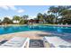 The community pool is surrounded by lounge chairs, lush trees, and a nearby pavilion at 34000 Fortunado St, Sorrento, FL 32776