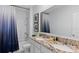 Elegant bathroom featuring a double sink vanity with granite countertops and modern fixtures at 3615 Salvia Ct, Tavares, FL 32778