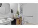 Compact bathroom with a modern sink and a toilet with grab bars, designed for accessibility at 3615 Salvia Ct, Tavares, FL 32778