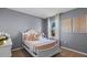 Charming bedroom with a decorative bedframe, pastel accents, and a window overlooking the outdoors at 3615 Salvia Ct, Tavares, FL 32778
