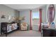 Charming Bedroom with a crib, comfortable chair, and soothing color palette at 3615 Salvia Ct, Tavares, FL 32778