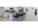 Kitchen island features bar seating, white cabinets and granite counters at 3615 Salvia Ct, Tavares, FL 32778