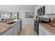 Bright open kitchen features granite countertops and stainless steel appliances at 3615 Salvia Ct, Tavares, FL 32778
