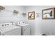 Efficient laundry room with modern washer and dryer and organized shelving at 3615 Salvia Ct, Tavares, FL 32778