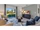 Bright living room with neutral furnishings, large sliding glass door to backyard, and entertainment center at 3615 Salvia Ct, Tavares, FL 32778