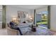 Living room boasts natural light through sliding doors, complemented by a stylish, neutral-toned sofa and decor at 3615 Salvia Ct, Tavares, FL 32778