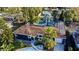 Aerial view of home with pool, solar panels, and lush landscaping at 3714 Virginia Dr, Orlando, FL 32803