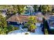 Aerial view of home with pool, solar panels, and lush landscaping at 3714 Virginia Dr, Orlando, FL 32803