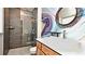 Beautiful bathroom with a modern vanity, framed mirror, decorative wall art, and a glass-enclosed shower at 3714 Virginia Dr, Orlando, FL 32803