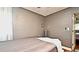 Bedroom featuring neutral tones, vinyl walls, wood floors, modern bedding, and great natural light at 3714 Virginia Dr, Orlando, FL 32803