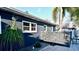 Backyard with a modern outdoor shower, decorative gravel, and beautiful landscaping at 3714 Virginia Dr, Orlando, FL 32803