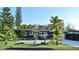 Charming single-story home featuring a vibrant yellow front door and lush tropical landscaping at 3714 Virginia Dr, Orlando, FL 32803