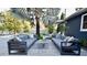 Beautiful patio with modern gray furniture, palm tree, and access to the pool at 3714 Virginia Dr, Orlando, FL 32803